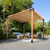 Wooden pergola with outdoor furniture under a clear blue sky