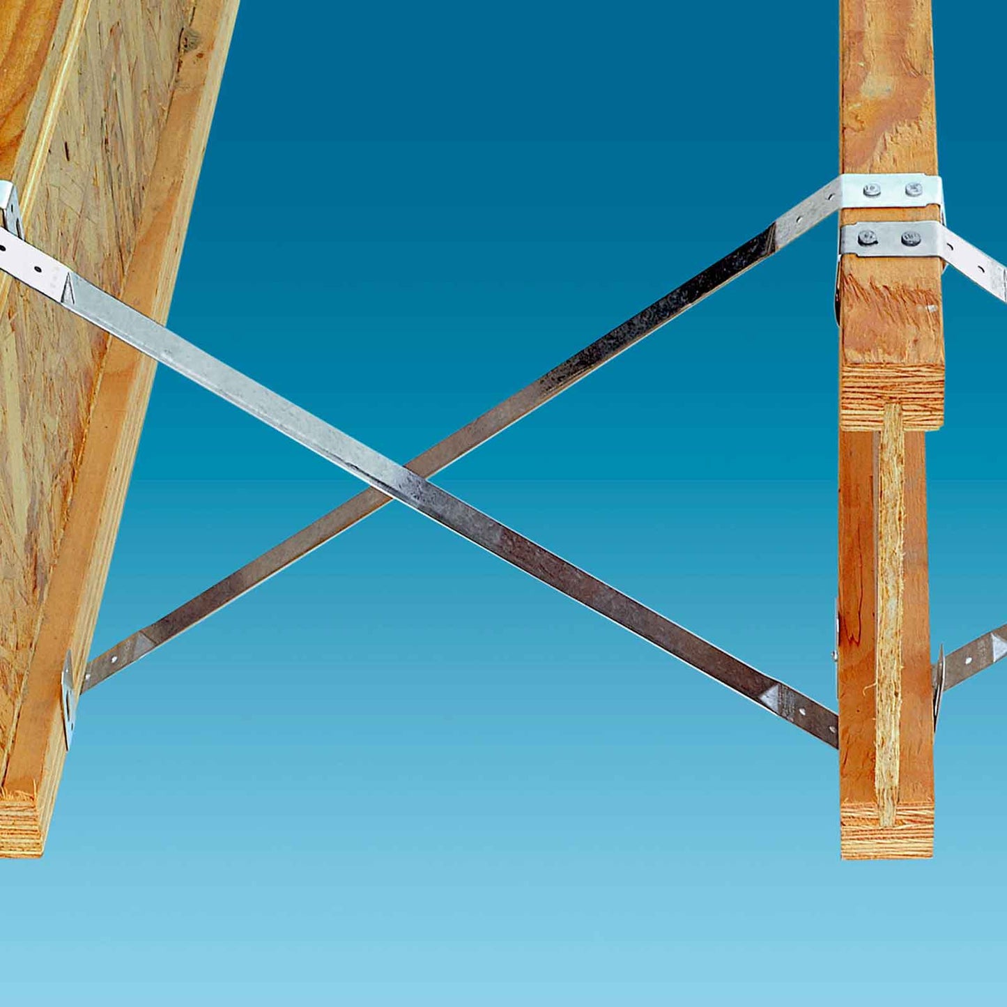 Wooden beams with metal tension bridging