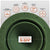 Green metal roof boot with features listed above it on a white background