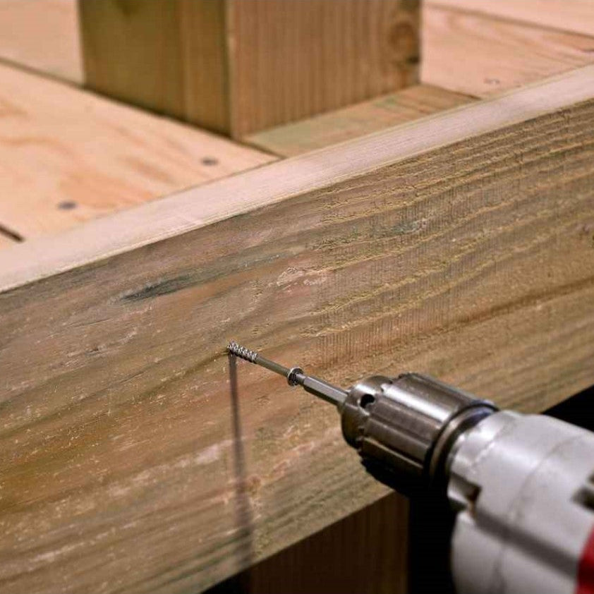 Drill bit being used on a wooden surface