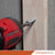 Red drill driving a concrete screw into a wooden board with 'Fasteners Plus' branding.