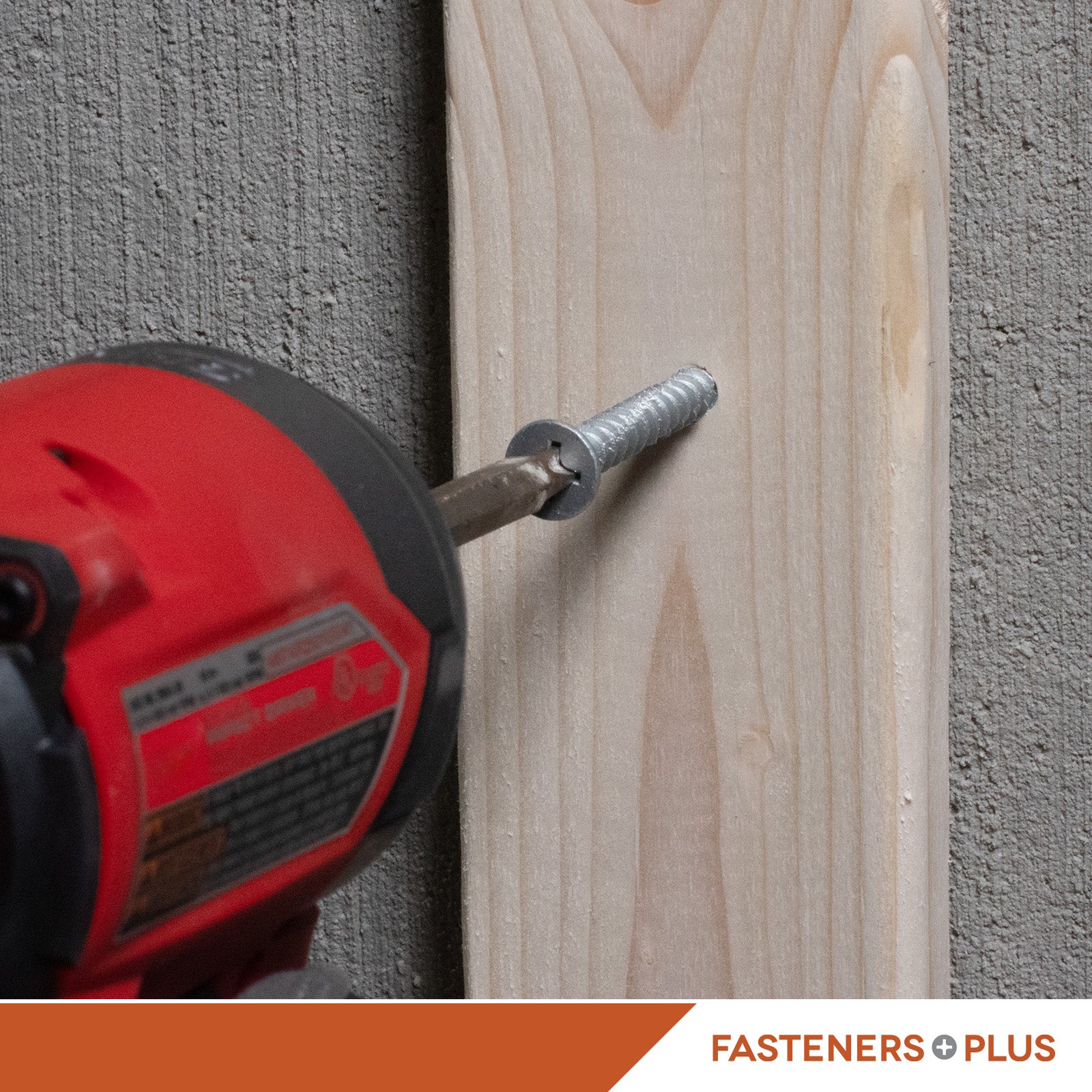 Red drill driving a concrete screw into a wooden board with 'Fasteners Plus' branding.