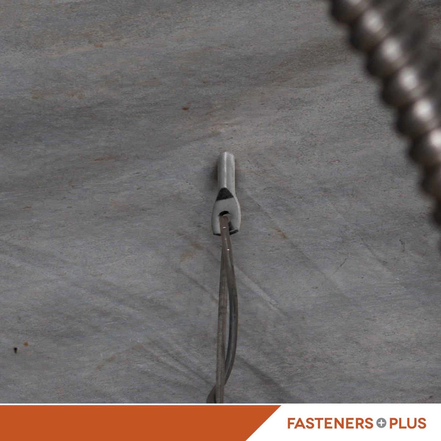 Tie wire wedge anchor installed in concrete