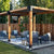 Completed Simpson Sage DIY Wooden Pergola with outdoor furniture on a patio area