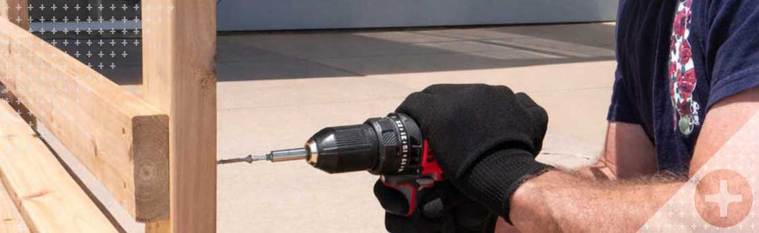 man drilling screw into wooden garden bench DIY