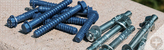 Tapcon+ concrete screws next to standard wedge anchors