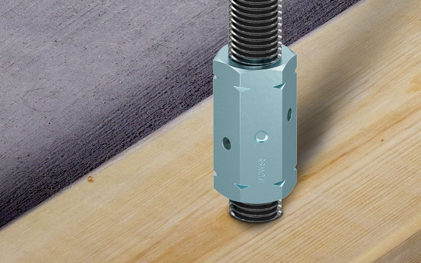 threaded rod with a coupler nut installed into wood and concrete