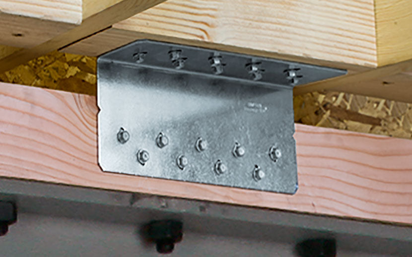 Metal heavy angle L shaped bracket on wooden beams with visible screw