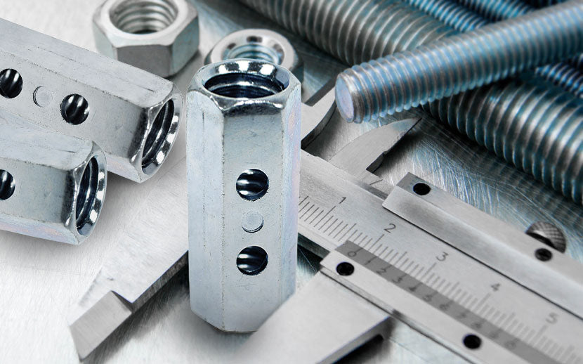 Coupler nuts and threaded rod with a ruler on a metallic surface