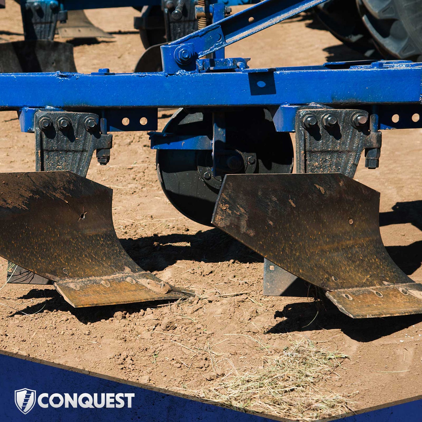 Close-up of a blue agricultural plow on a field