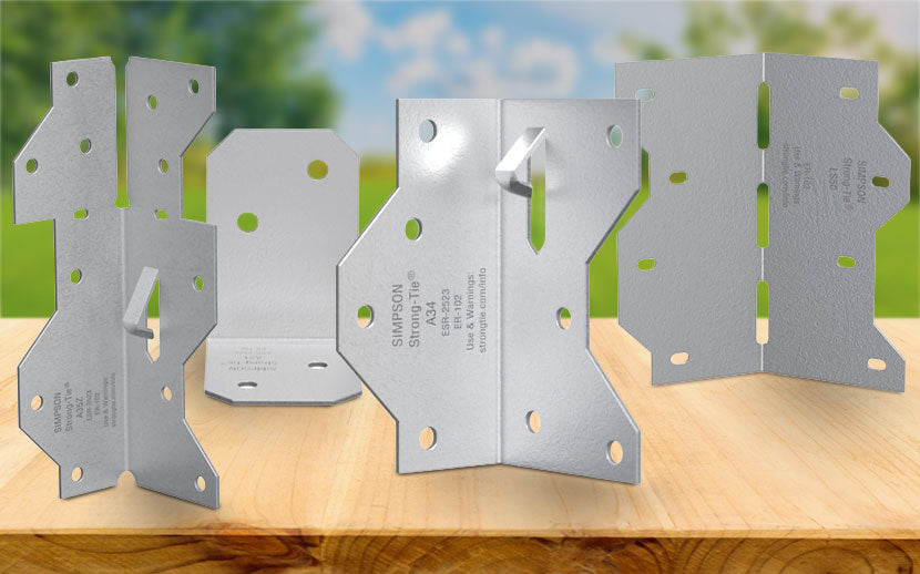 Metal framing angles on a wooden surface with a blurred natural background