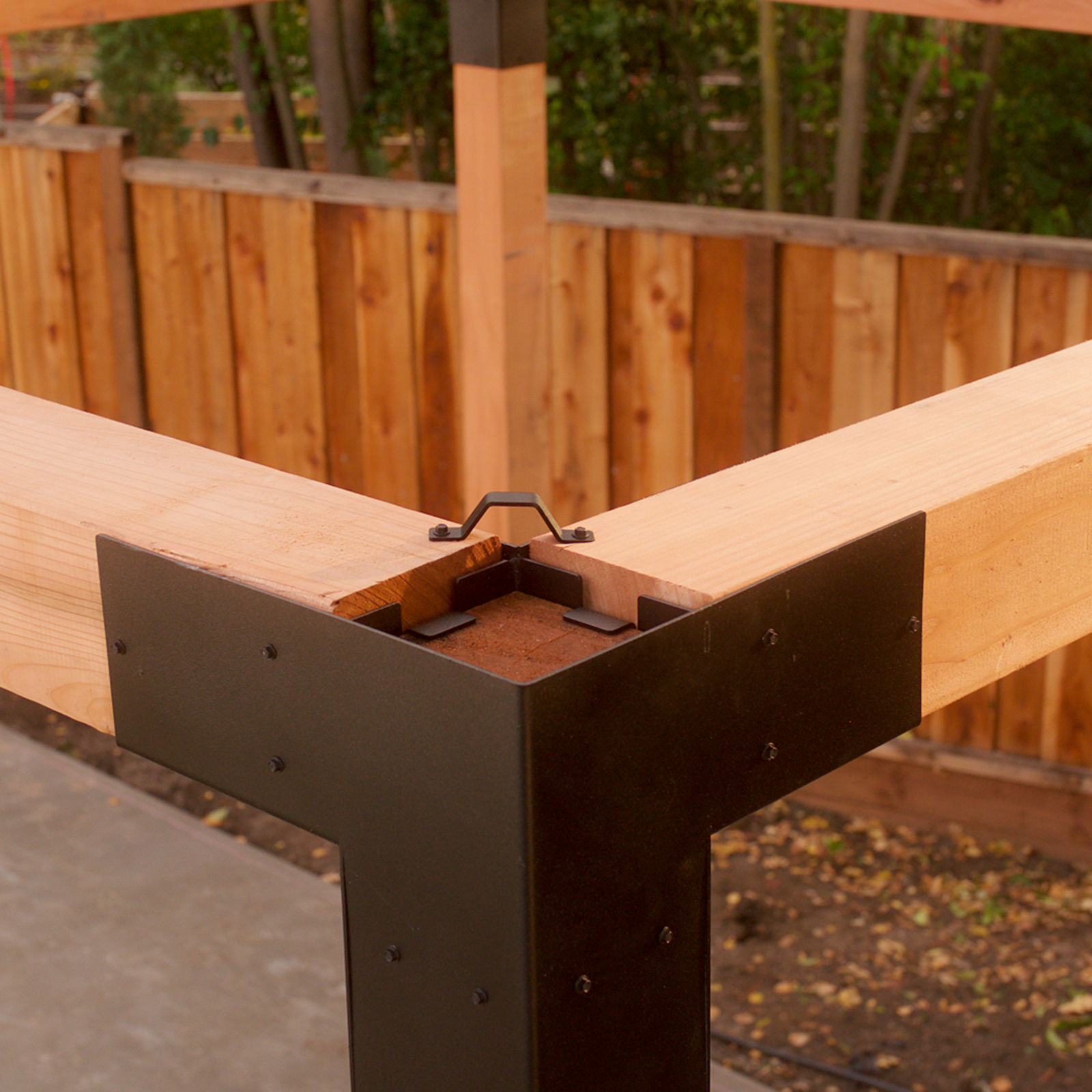 Wooden beams connected using Simpson Sage Corner Connectors from the DIY Pergola Kit