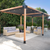 Outdoor patio with pergola, furniture, and plants on a sunny day.