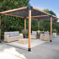 Outdoor patio with pergola, furniture, and plants on a sunny day.
