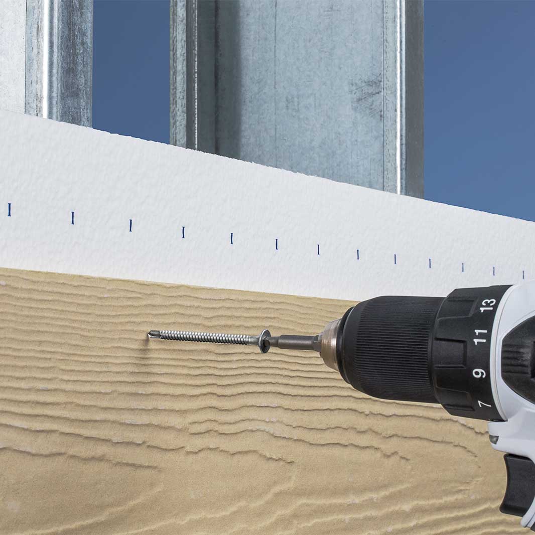 Screw being installed into wood with a drill