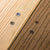 Close-up of wooden planks with screws, showing a close-up detail of the wood texture and screws.
