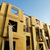 Building under construction with wooden frames against a clear blue sky