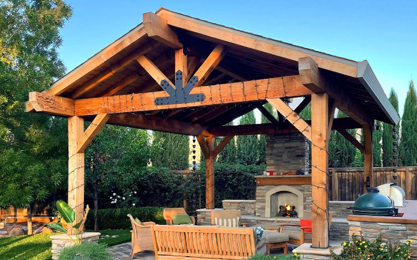Wooden pergola with outdoor furniture and fireplace in a garden setting