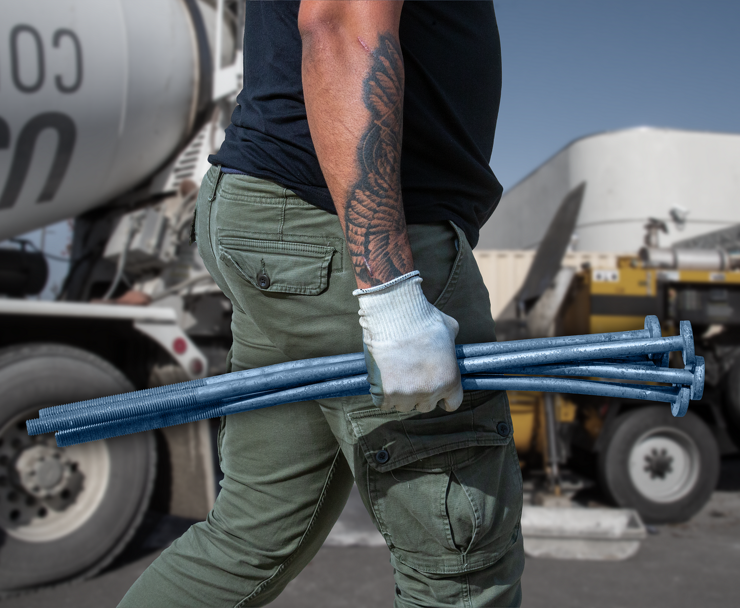 Construction worker carrying a Simpson Anchor Bolts in his hand on a construction site