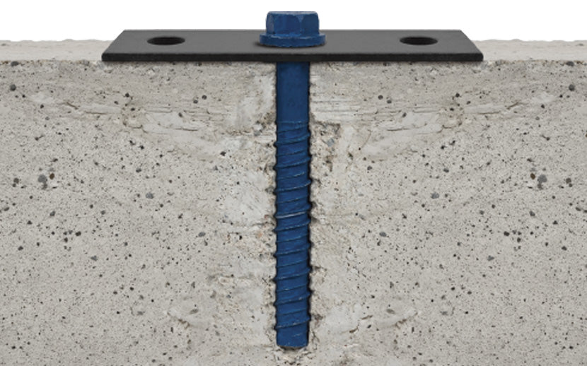 A blue threaded anchor screw with a black metal mounting plate, shown installed vertically into a textured concrete surface.