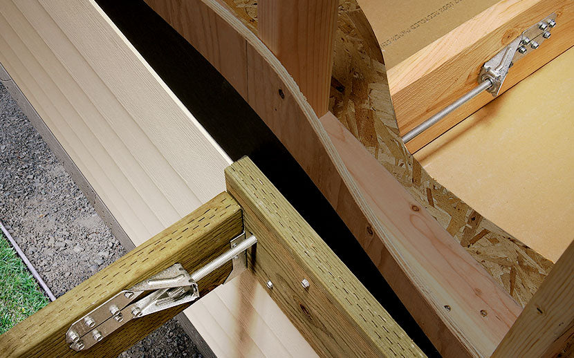 Metal tension ties in house and exterior wooden decking