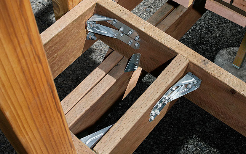 Wooden beams with metal tension ties on a construction site