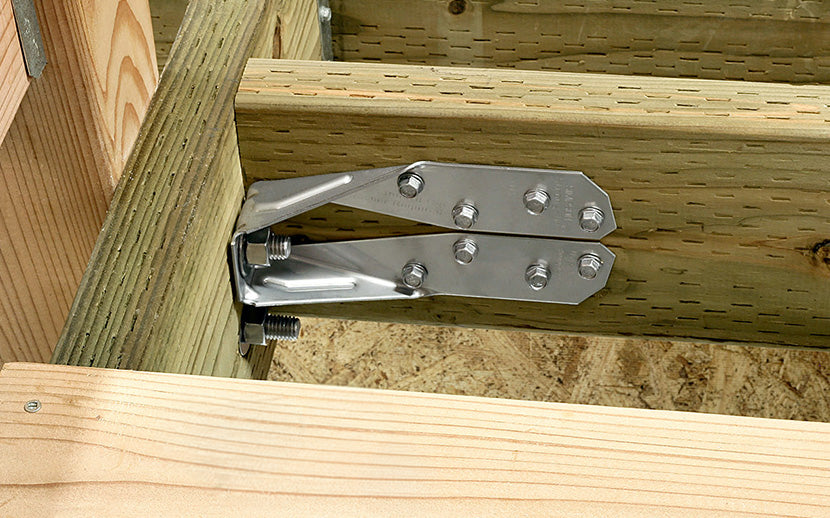 Metal tension tie attached to wooden beams