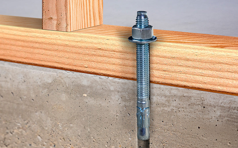 Wedge anchor installed in wooden beams on a concrete floor