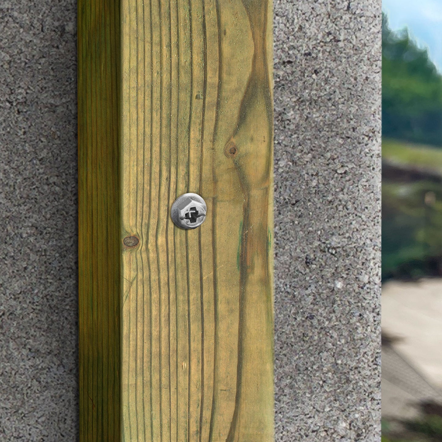 Wooden post with a Titen Turbo screw against a concrete wall